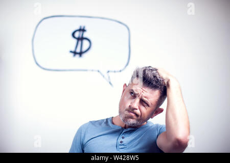 Portrait of a young man with a speech bubble dollar signe over his head Stock Photo