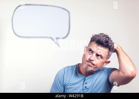 Portrait of a young man with a empty speech bubble over his head Stock Photo
