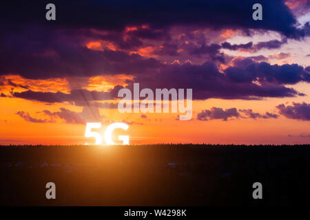 5G rises above the horizon. Network wireless systems and internet of things on surise background. Concept of future technology Stock Photo