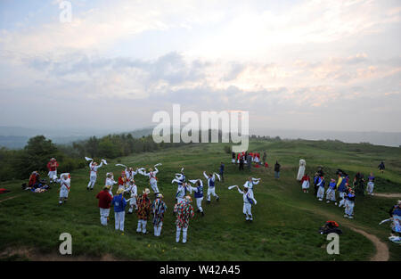 Morris Dancing on top of Painswick Beacon to celebrate sunrise on May Day Stock Photo