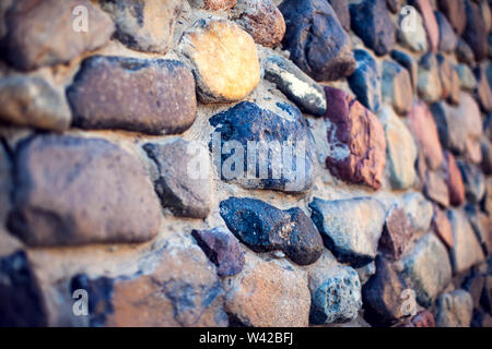 Natural colorful pebbles background on beach in summer for wall design and natural background concept in summer. Stock Photo