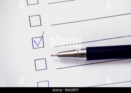 Checklist boxes with pen on white paper. Check form concept Stock Photo