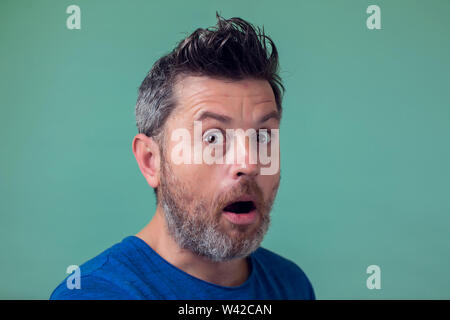 People and emotions - man with beard surprised about something Stock Photo
