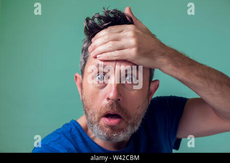 People and emotions - man with beard surprised about something Stock Photo