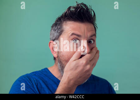 People and emotions - man with beard surprised about something Stock Photo