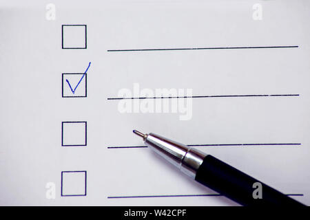 Checklist boxes with pen on white paper. Check form concept Stock Photo