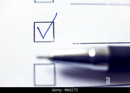 Checklist with a pen on white paper. Checkbox concept. Stock Photo