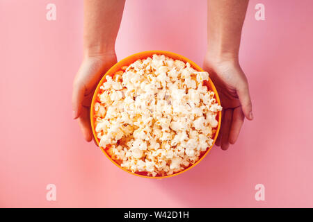 A bowl with popcorn on pink background. Food and entertaiment concept Stock Photo