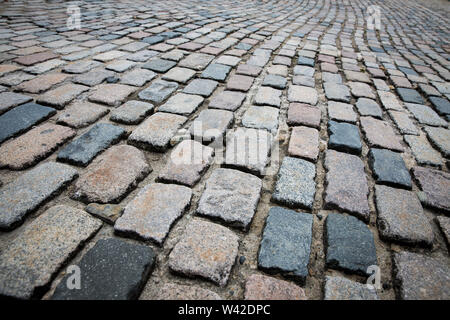 A full frame background image of rows of cobblestones stretching into the distance on a cobble street with copy space Stock Photo