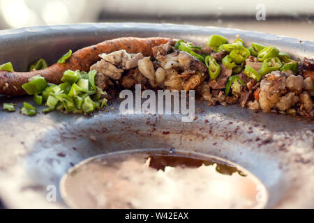 Rice-stuffed sausages called Mombar and vegetables on the plate. Traditional food of Egypt Stock Photo