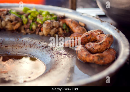 Rice-stuffed sausages called Mombar and vegetables on the plate. Traditional food of Egypt Stock Photo