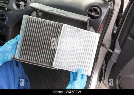 Replacing an old car cabin air filter Stock Photo