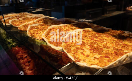 Lahmacun, Traditional turkish pizza with minced meat, street food. Store window display in Rotterdam, closeup view Stock Photo