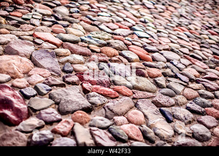 Pebble wall are made of stones of different sizes. Natural background Stock Photo