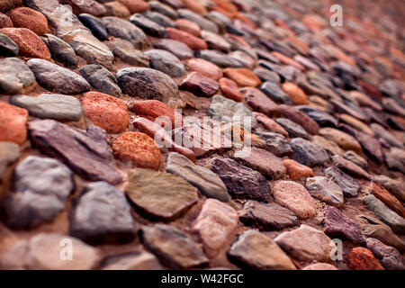 Pebble wall are made of stones of different sizes. Natural background Stock Photo