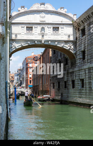 View of the Bridge of Sighs from the Rio de Palazzo with passing tourist enjoying rides in gondolas,Venice,Italy Stock Photo