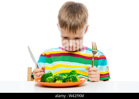 emotional portrait of a boy who doesn't like to eat broccoli, shooting in the studio Stock Photo