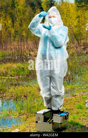 environmentalist study of the composition of water in the lake, a portrait in nature while working Stock Photo
