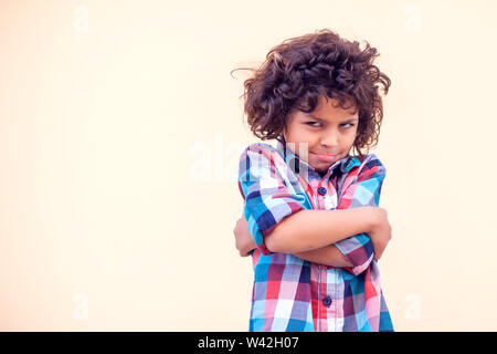 Closeup portrait of shy little kid with curly hair Stock Photo