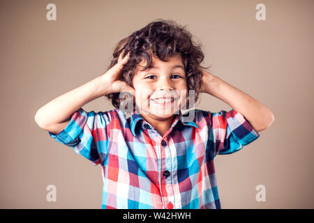 Young boy with covering his ears with hands.Children and emotions concept Stock Photo