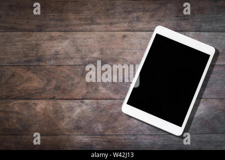 white tablet with blank screen on wooden table Stock Photo