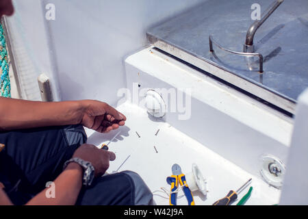 A man worker fix socket in the wall. Stock Photo