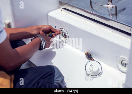 A man worker fix socket in the wall. Stock Photo