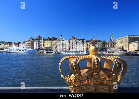 Scenic view of Stockholm's Old Town (Gamla Stan) skyline with the royal golden crown on the foreground, Sweden Stock Photo