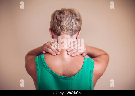 Woman with short hair feels strong neck pain isolated. People, healthcare and medicine concept Stock Photo