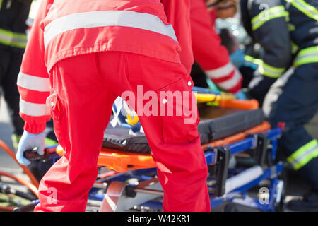 Paramedics and firefighters in urgent rescue operation after a car crash Stock Photo