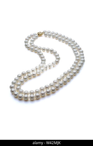 Double strand white pearl necklace with gold clasp. Set on a white background with a shadow under the pearls.