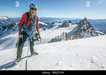 A seasoned alpinist full of stoke on a bluebird day in the French Alps Stock Photo