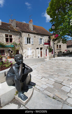 Chauvigny, France. Chauvigny’s piazza at Rue des Puys, with a bronze statue of a young female, by Francois Peyrat, in the foreground. Stock Photo