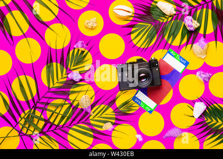 Flat lay traveler accessories with palm leaf, seashells, camera . Top view travel or vacation concept. Summer background. Stock Photo
