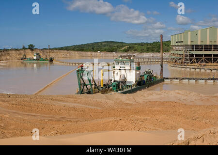 Managing & transporting of titanium mineral sands at mine site. Mining by dredging in freshwater ponds. Dredges pump sand into wet concentrator plant. Stock Photo