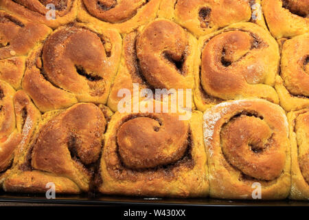 Freshly baked mould of sweet spicy pumpkin buns. Halloween sweets Stock Photo