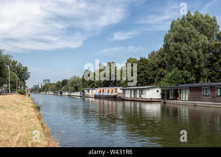 Dutch canal in city Utrecht with moored houseboats Stock Photo