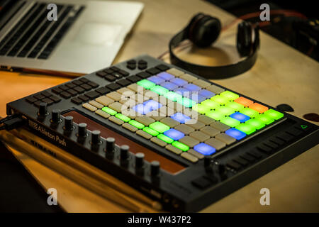 Home music production. An Ableton Push midi pad controller with Macbook and Headphones Stock Photo