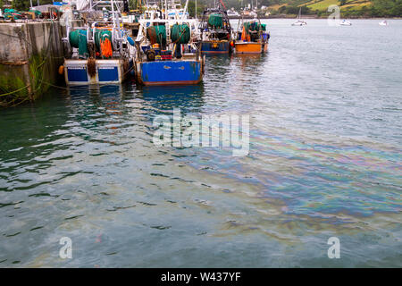 Diesel spill from trawler polluting sea in Union Hall harbour Ireland Stock Photo