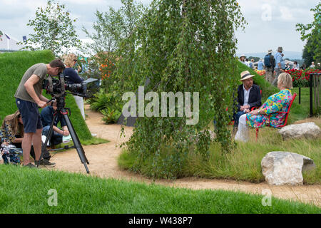 Joe Swift interviewing Sue Biggs in the RHS Bridgewater show garden at RHS Tatton Park flower show 2019. Tatton Park, Knutsford, Cheshire, England Stock Photo