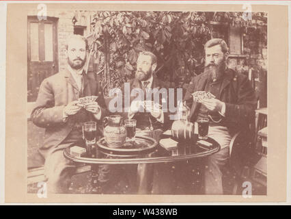 Victorian Cabinet Card Showing a Group of Three Bearded Men Sat Outside at a Table. The Men are Playing Cards (Gambling) and Drinking Alcohol. Stock Photo