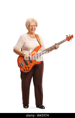 Full length portrait of a senior woman with an electric bass guitar smiling at the camera isolated on white background Stock Photo