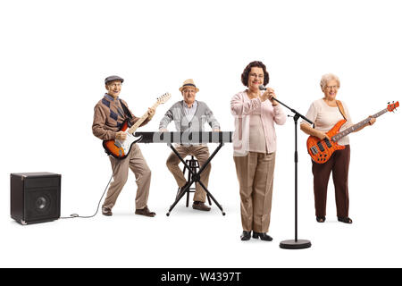 Full length portrait of an elderly female singing and an elderly men and woman playing guitars and keyboard isolated on white background Stock Photo