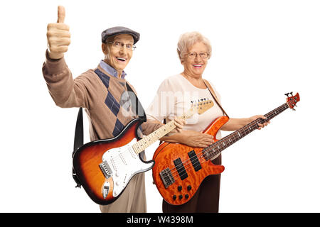 Elderly man and woman with electric guitars showing thumbs up isolated on white background Stock Photo