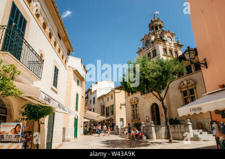 Alcudia, Mallorca, Spain - May 23, 2015: Architecture of Majorca. The tower with big clock of City town hall in Old Town of Alcudia, Mallorca, Baleari Stock Photo