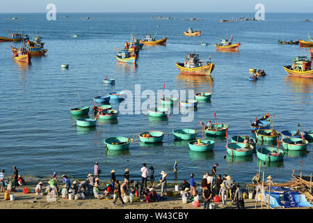 Phan Thiet, Vietnam - Mar 19, 2016. Many boats and local people at fishing pier in Mui Ne town, Phan Thiet, Vietnam. Mui Ne is a coastal fishing town Stock Photo