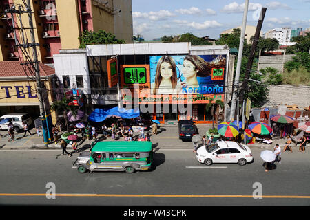 Manila, Philippines - Dec 21, 2015. Cars run on street at Chinatown in Manila, Philippines. Manila is a major center for commerce, banking and finance Stock Photo