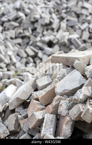 Pile of dismounted gray modern urban pavement bricks with selective focus. Result of russian government corruption in city infrastructure renovation. Stock Photo