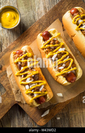 Homemade detroit style chili dog with yellow mustard and onion on a ...