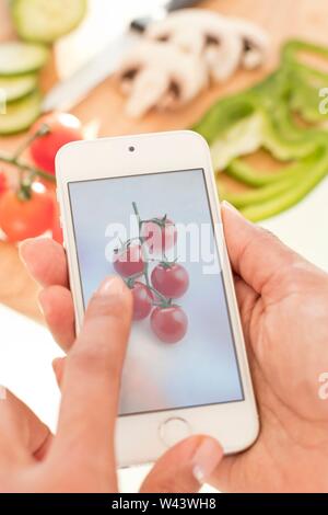 Woman checking calories on smartphone. Stock Photo